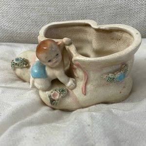 Selling a baby with booties planter or vase.